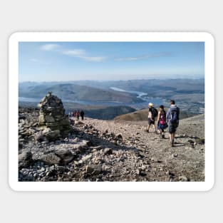 Hikers pass a navigation cairn as they descend back down Ben Nevis Sticker